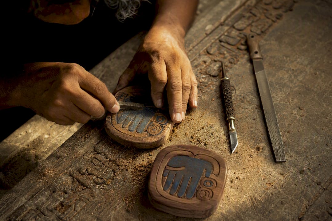Hands carving Blue Hand Mayan glyph