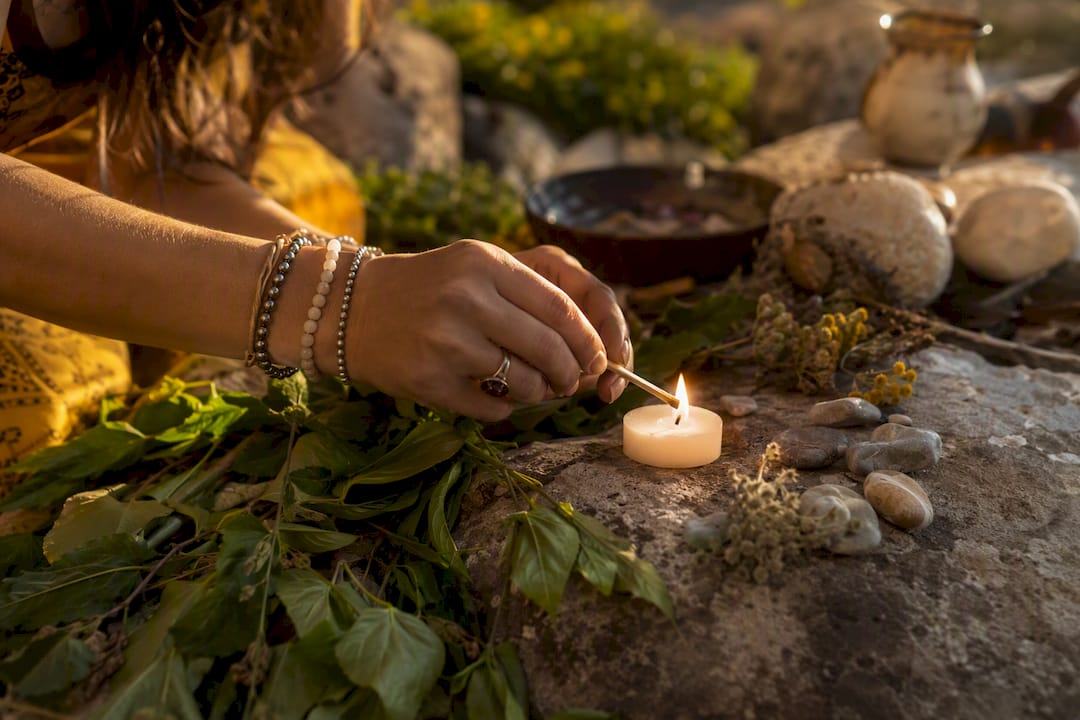 Hands lighting candle for Venus ritual
